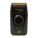 A black Stylecraft Absolute Zero electric shaver with a gold-toned triple-edge blade and a green indicator light, shown against a plain light gray background.