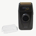 Stylecraft Absolute Zero electric shaver in black with gold trim, shown next to a clear protective cover on a light gray background.