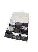 BarberMate Pro Blade Rack black with the word BARBERMATE in gold on front shown on white background with clipper and trimmer blades in the blade slots of the blade holder case with clear lid 